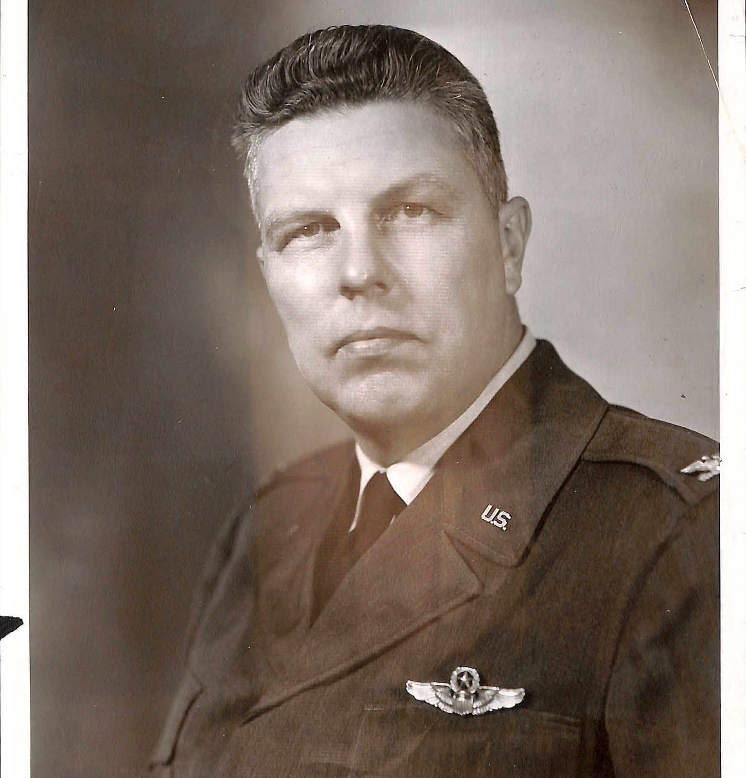 DOW-UAP-D180: official studio portrait of Colonel Howard M. McCoy, U.S. Air Force, in service uniform with pilot wings, U.S. collar insignia and colonel's eagle, from his final personnel record. The photograph is undated; a second print of the same portrait appears on page 296.